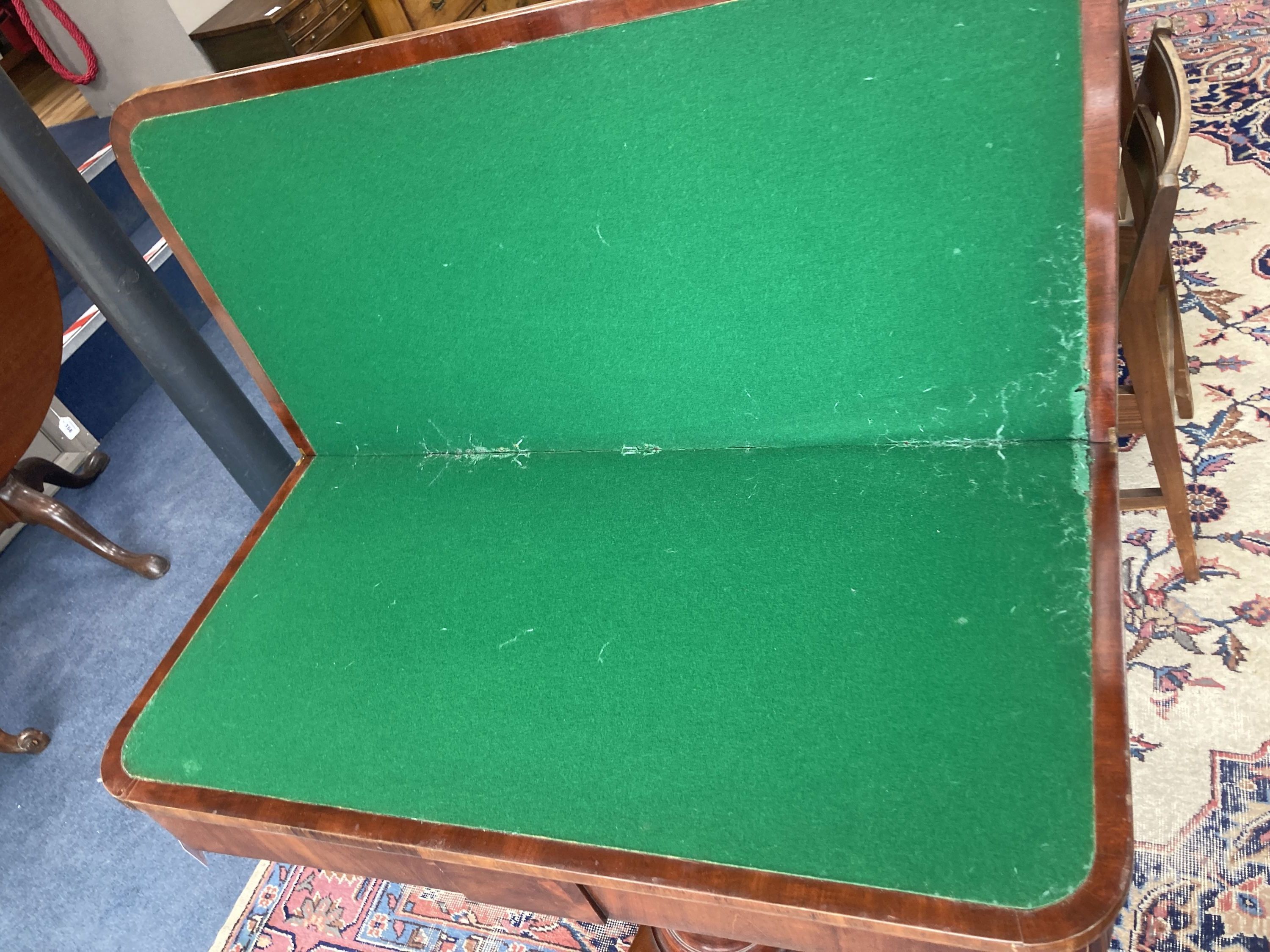 A Victorian mahogany folding card table in flamed veneers, 91cm diameter (91 x 45cm closed), 76cm high
